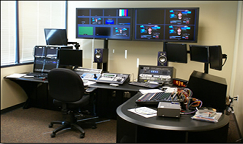 Control room with computers and equipment.